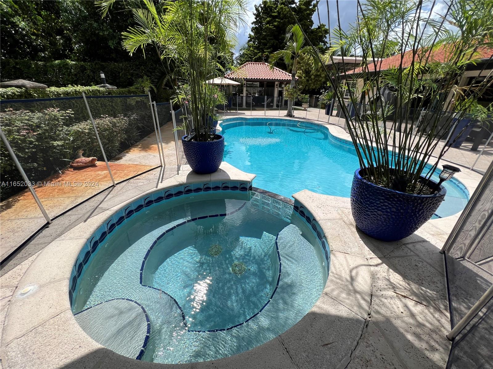 11866 Southwest 43rd Street Miami, FL 33175 - Photo 50 of 64 a swimming pool with outdoor seating and plants