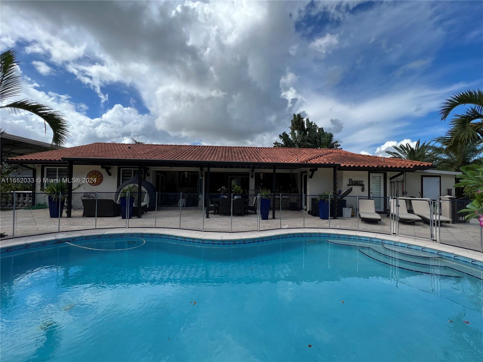 11866 Southwest 43rd Street Miami, FL 33175 - Photo 51 of 64 a view of a large building with a big yard and plants