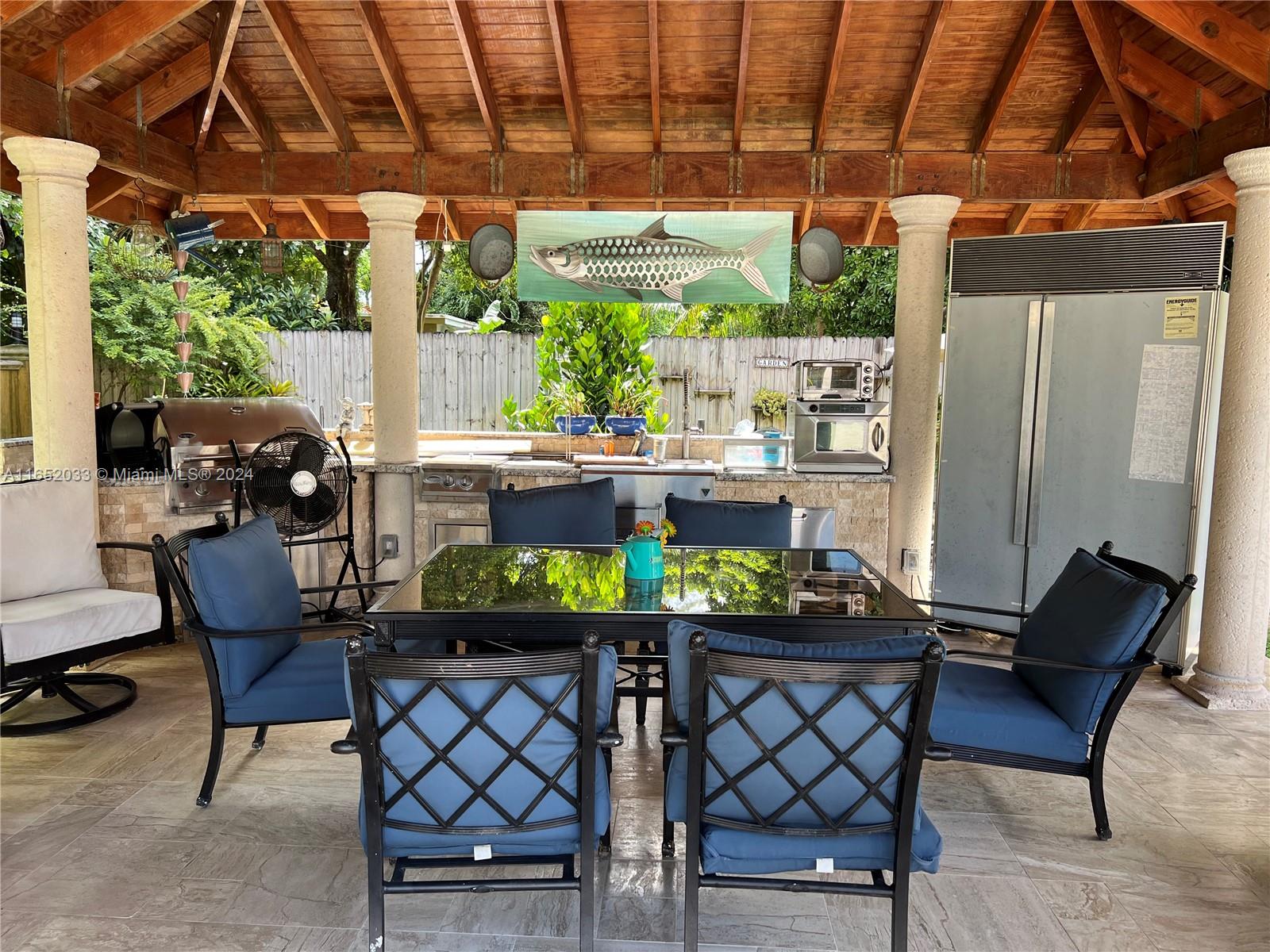 11866 Southwest 43rd Street Miami, FL 33175 - Photo 53 of 64 a table and chairs in front of a room