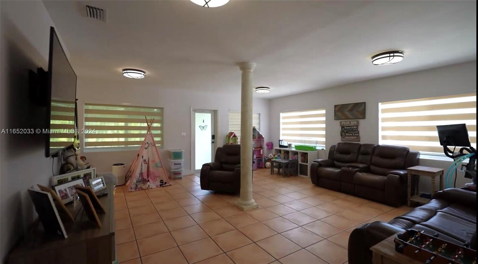 11866 Southwest 43rd Street Miami, FL 33175 - Photo 9 of 64 a living room with furniture a flat screen tv and a window