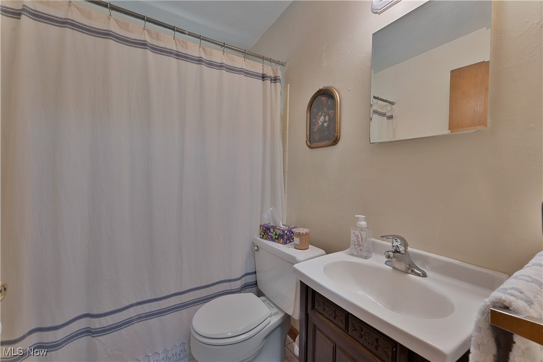 9925 Struthers Road New Middletown, OH 44442 - Photo 9 of 12 Bathroom featuring vanity and curtained shower