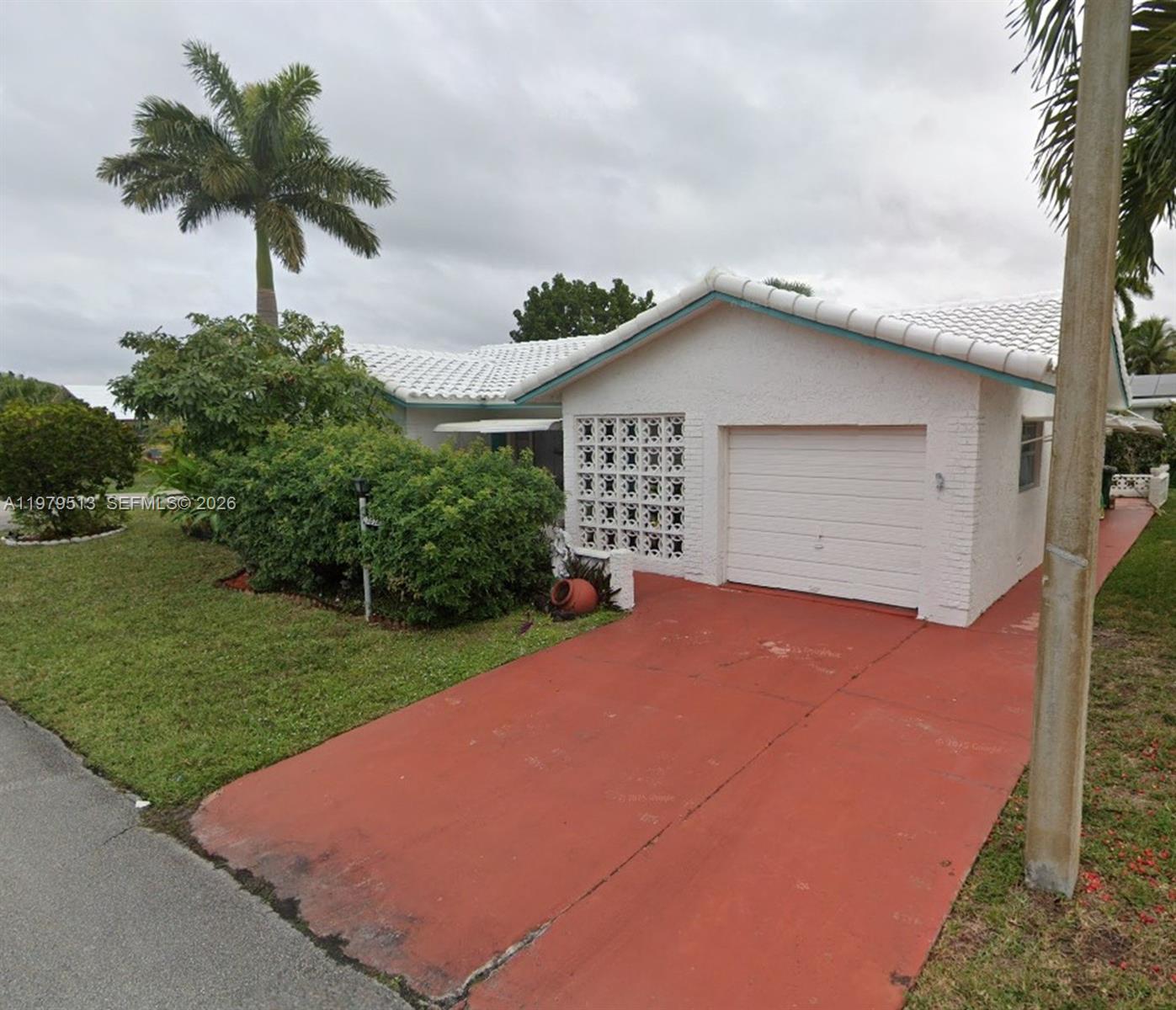 7516 Northwest 67th Avenue Tamarac, FL 33321 - Photo 1 of 1 a front view of a house with a yard and garage