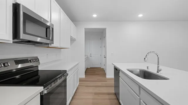 a kitchen with a sink and stainless steel appliances