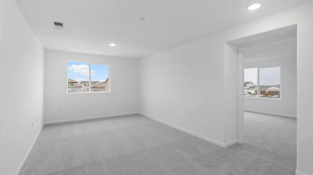 an empty room with a mirror and a wooden door