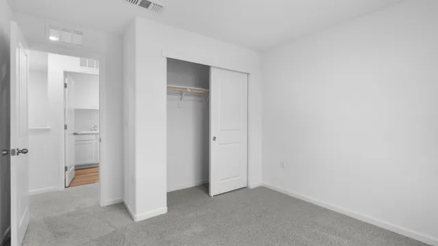 an empty room with closet area