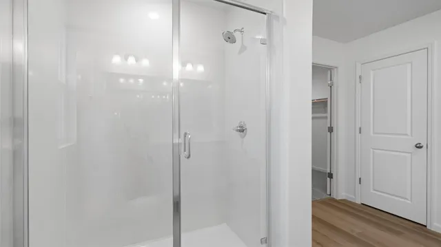 a bathroom with a glass shower door