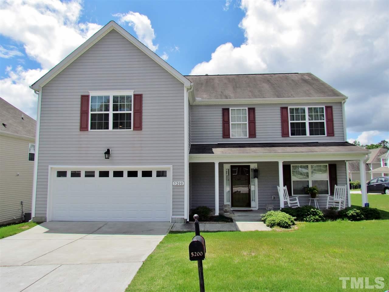 5200 Chasteal Trail Raleigh, NC 27610 - Photo 1 of 25 a front view of a house with a yard and garage