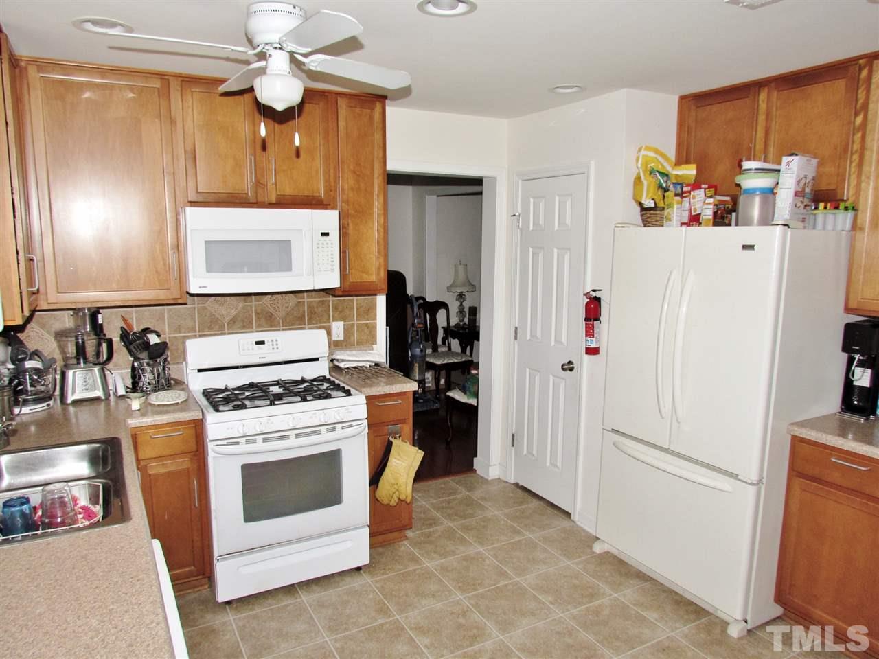 5200 Chasteal Trail Raleigh, NC 27610 - Photo 12 of 25 a white refrigerator freezer sitting inside of a kitchen
