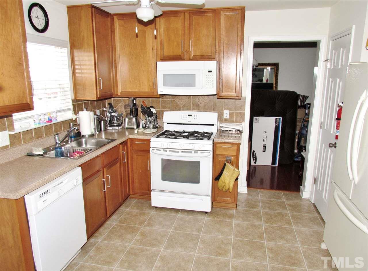 5200 Chasteal Trail Raleigh, NC 27610 - Photo 13 of 25 a kitchen with a stove a sink and a refrigerator