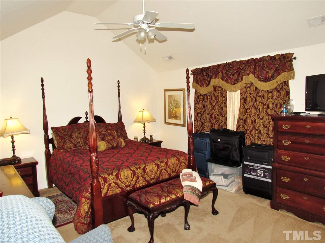 5200 Chasteal Trail Raleigh, NC 27610 - Photo 17 of 25 a bed room with a bed and a chandelier