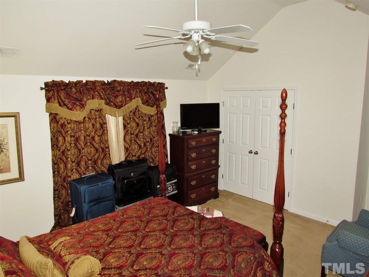 5200 Chasteal Trail Raleigh, NC 27610 - Photo 18 of 25 a bedroom with a bed and a television