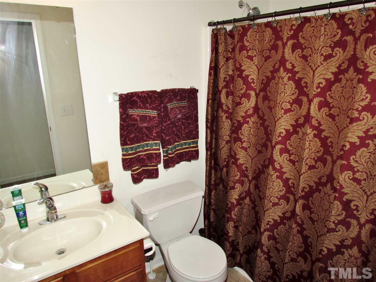 5200 Chasteal Trail Raleigh, NC 27610 - Photo 19 of 25 a white toilet sitting next to a bathroom sink