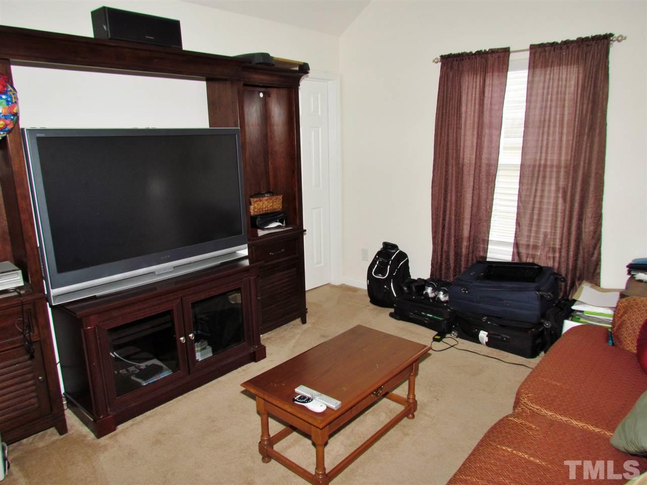 5200 Chasteal Trail Raleigh, NC 27610 - Photo 21 of 25 a living room with a fireplace and a flat screen tv