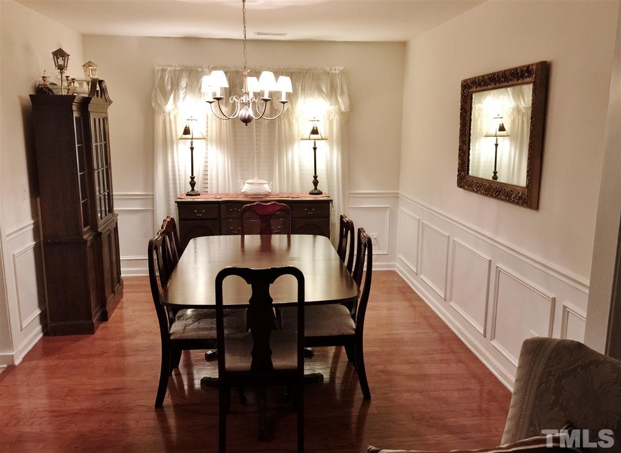 5200 Chasteal Trail Raleigh, NC 27610 - Photo 7 of 25 a view of a dining room with furniture and wooden floor
