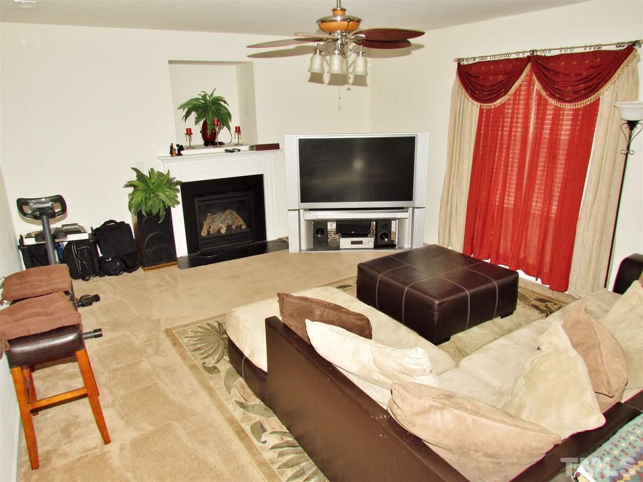 5200 Chasteal Trail Raleigh, NC 27610 - Photo 8 of 25 a living room with furniture and a flat screen tv