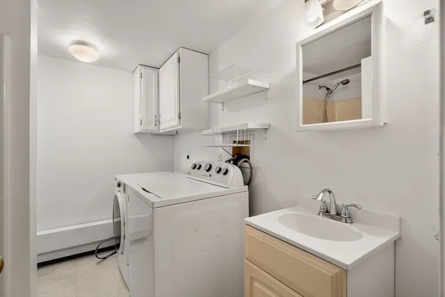 a view of an empty room with a fireplace and a window