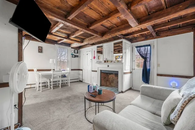 a dining room with stainless steel appliances a chandelier and a table