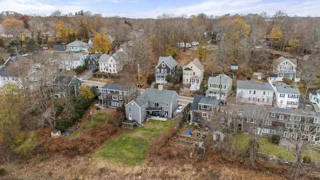 an aerial view of a house with a mountain