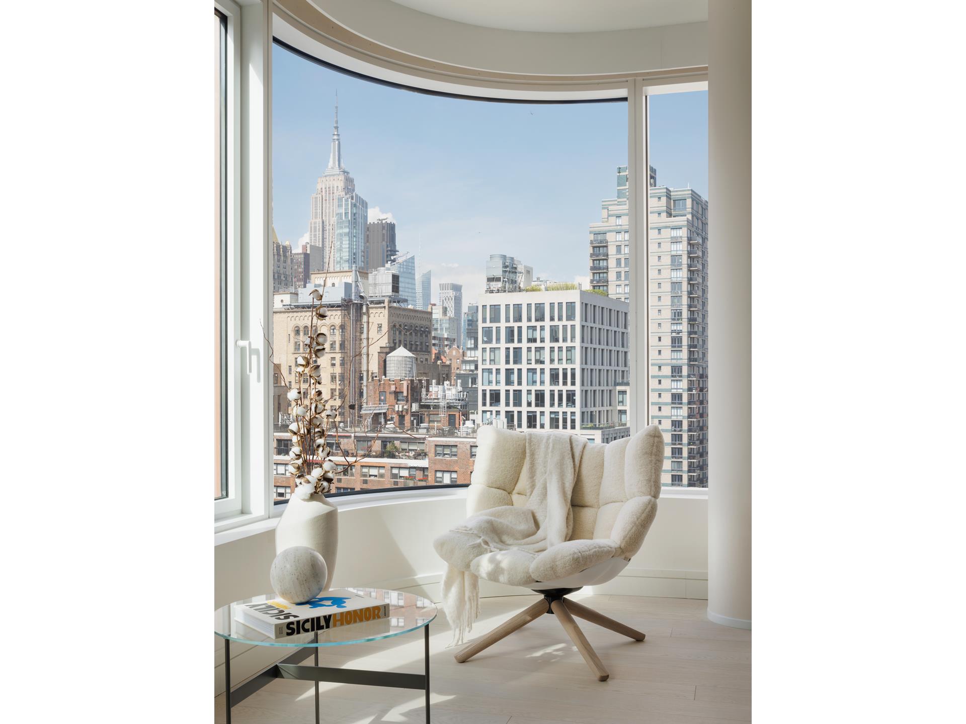 200 East 20th Street, Unit 12B Manhattan, NY 10003 - Photo 3 of 19 a living room with furniture and a floor to ceiling window