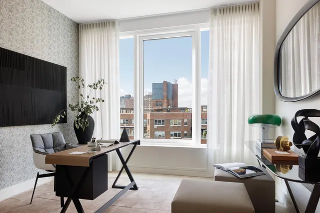 a bedroom with a bed a mirror and a large window