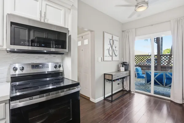a kitchen with stainless steel appliances a stove a microwave a sink and cabinets