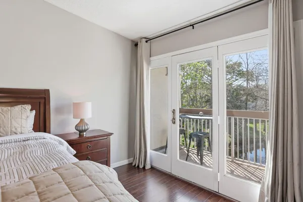 a large bed sitting in a bedroom next to a window