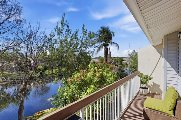 a bedroom with a large bed and wooden floor