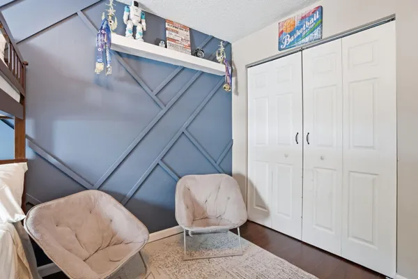 a bedroom with furniture and a window
