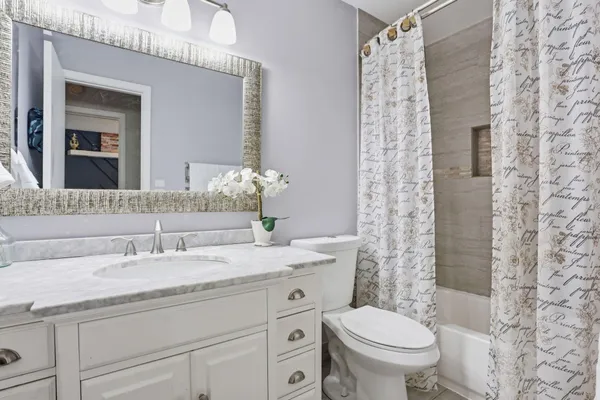 a view of a hallway with wooden floor and cabinet