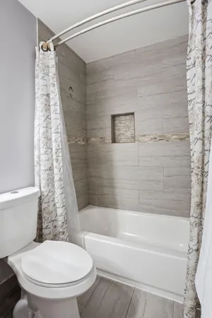 a bathroom with a granite countertop sink a toilet and a mirror