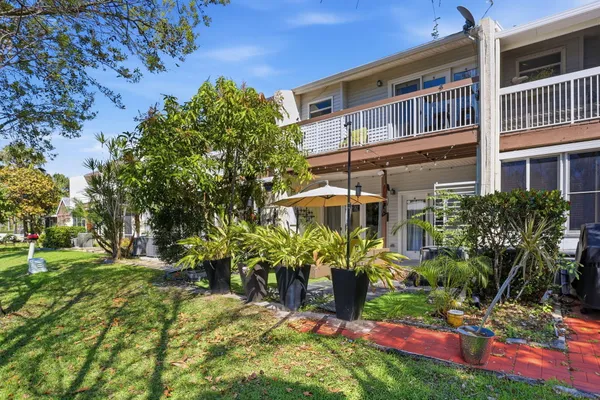 a view of a backyard with plants and a patio
