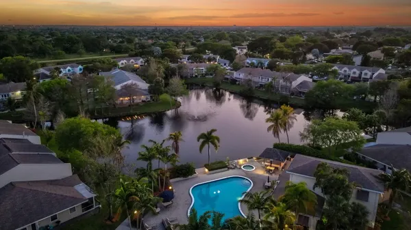 an aerial view of a city with lots of residential buildings and mountain view in back