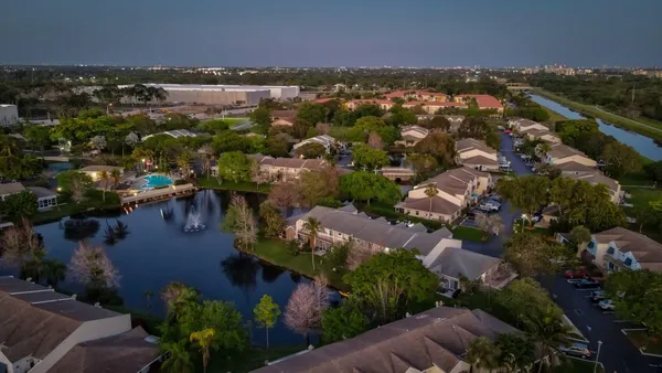 an aerial view of a house with outdoor space and lake view