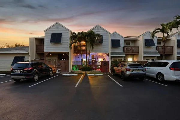 a view of a house with a yard and a fountain