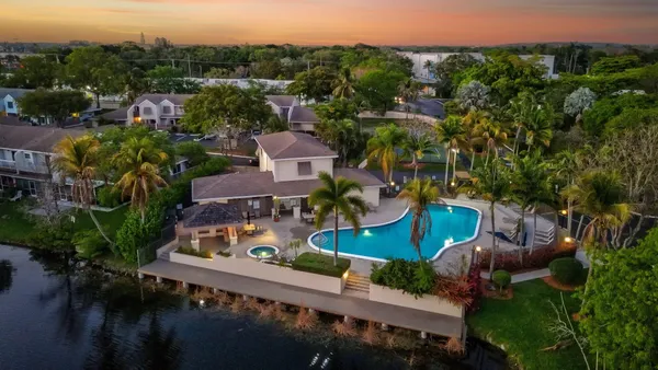 an aerial view of multiple houses with yard