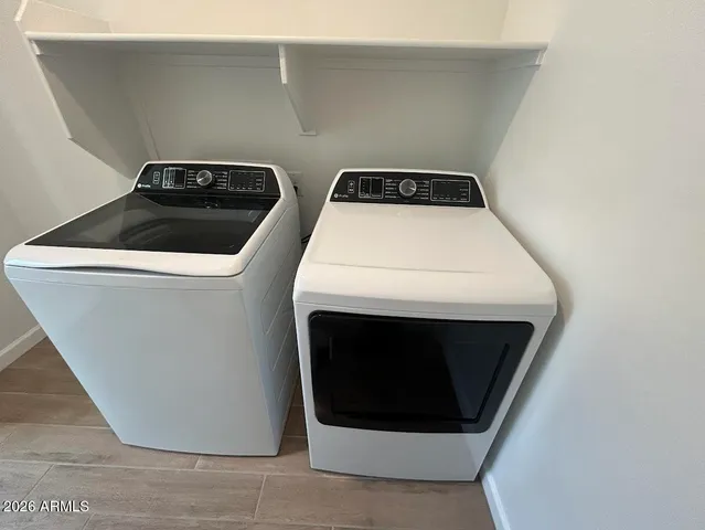 a view of a chairs and table in the balcony