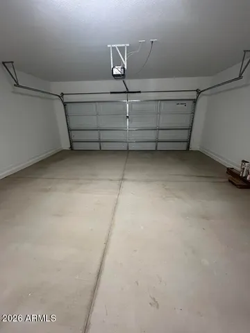 an empty room with windows and ceiling fan