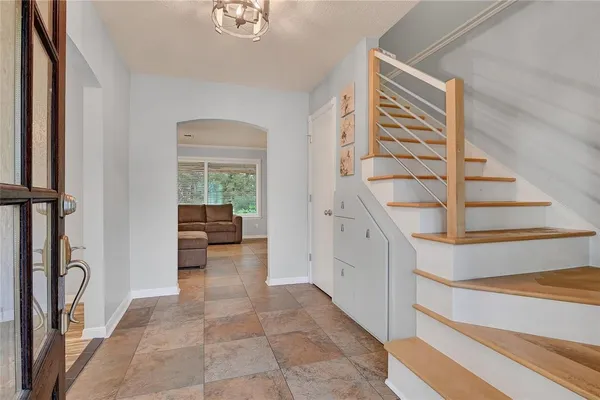 an empty room with a chandelier fan