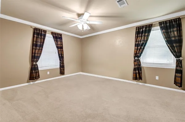 a front view of a house with a yard table and chairs