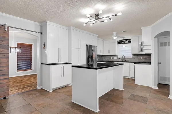 a kitchen with granite countertop a sink and cabinets
