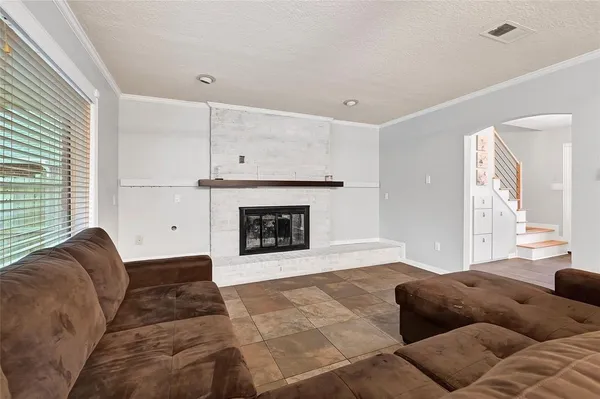 a view of empty room with wooden floor and window