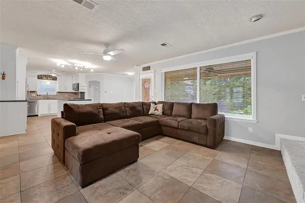 a view of a room with wooden floor and fan