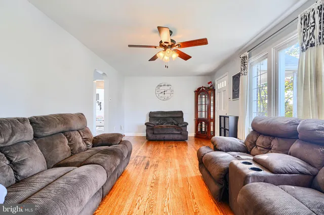 a living room with furniture ceiling fan and a rug