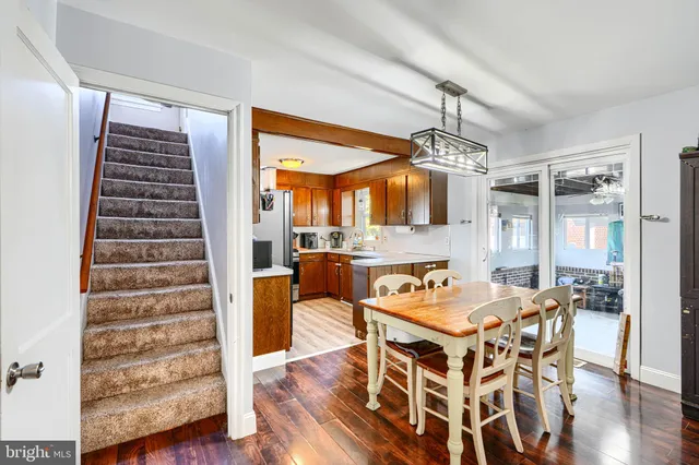 a dining room with furniture and wooden floor
