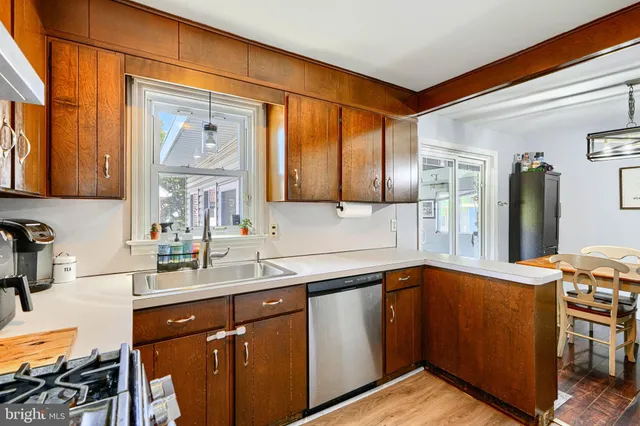 a kitchen with a sink cabinets and a window