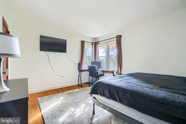 a bedroom with a bed and a lamp on table