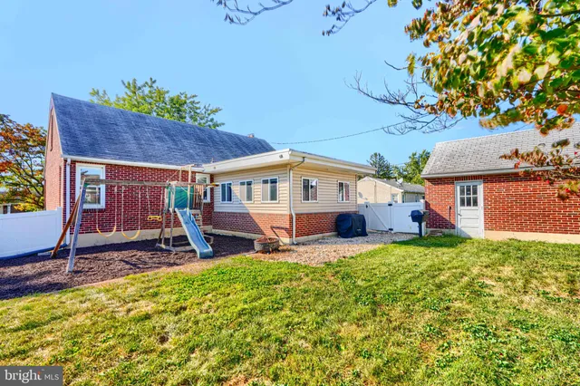 a front view of a house with a yard porch and sitting area