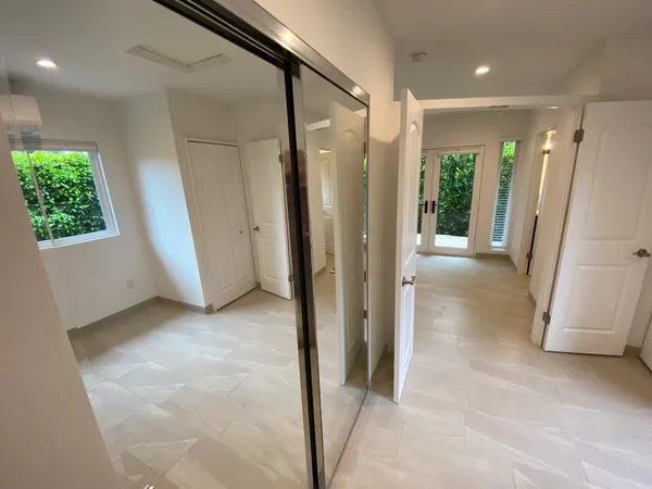 an empty room with windows and closet