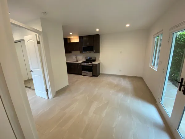 a bathroom with a granite countertop toilet and a mirror