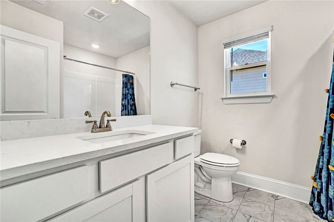 142 Juniper Hill Drive Easley, SC 29642 - Photo 39 of 47 This bright bathroom features a vanity with ample counter space and classic tile flooring.